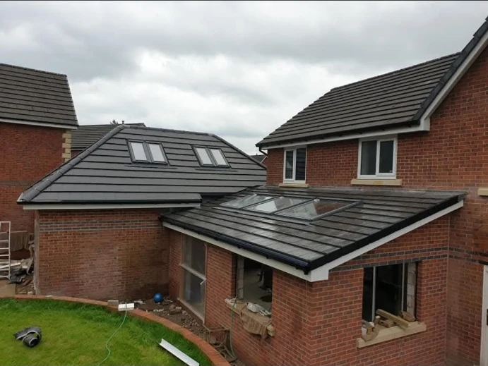 Brick house extension with a tiled roof and rooflights