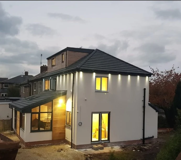 Rendered house with a new dormer and illuminated exterior